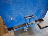 a blue container sitting on top of a wooden pallet