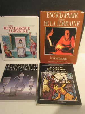 three books on a table with a glass of wine in front of them