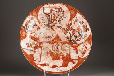 a red and white plate with flowers and birds on it