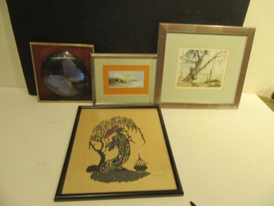 three framed pictures on a table next to a pair of scissors