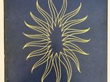 a blue book with a gold sun design on it