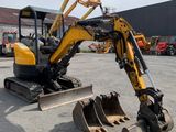 a small excavator that is parked in the parking lot