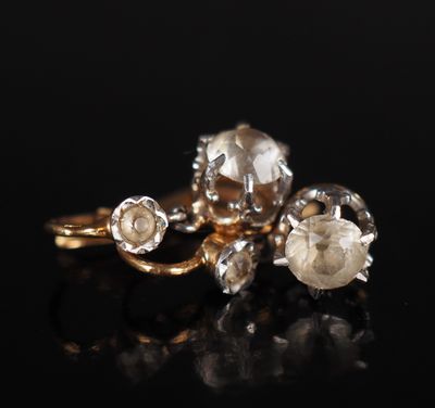 a close up of a gold ring with three diamonds on it