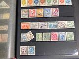 a lot of different stamps on a book on a table