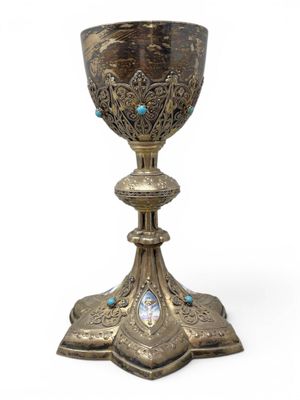 an image of a silver cup with blue stones on it