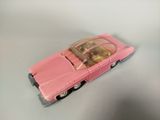 a pink toy car that is sitting on a table