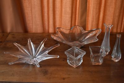 several pieces of glass sitting on top of a wooden table