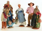 five figurines of people dressed in traditional clothing