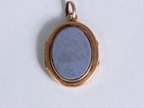 a picture of a gold locke with a blue stone in it