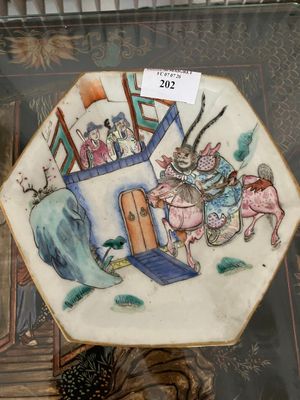 a plate with a picture of a man riding a horse
