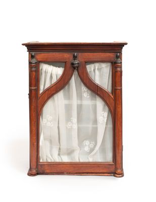 an old wooden display case with a curtain on top of it