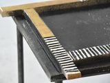 a black and white table with a gold frame on top of it