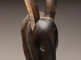 a close up of a wooden sculpture of a goat ' s head
