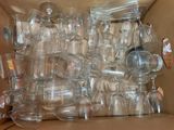 a box full of empty wine glasses sitting on top of a table
