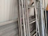 a lot of old metal ladders stacked on top of each other