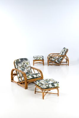 four chairs and a table in a room with white walls