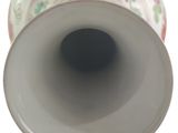 a white vase with a floral design on it