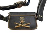 a black leather bag with a metal buckle on it