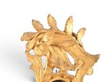 a gold clock with a bird on top of it