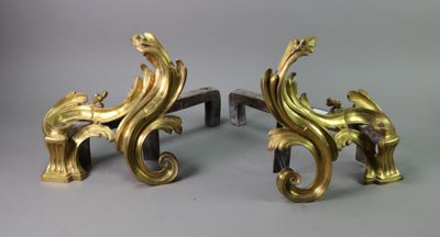 two gold colored sculptures on a gray surface