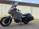 a silver motorcycle parked in front of a building