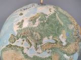 a large globe with a map on top of it