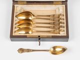 four spoons and a spoon in a wooden box