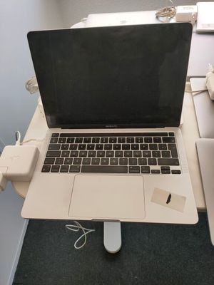 a laptop computer sitting on top of a desk next to a mouse