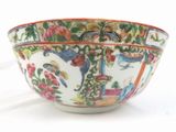 a white bowl with colorful designs on it on a white surface
