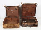 two old suitcases sitting next to each other on a table