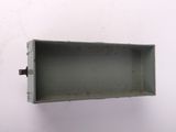 a metal box with a hole in it on a white wall