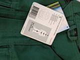 a credit card sitting in the pocket of a pair of green pants