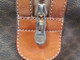 a close up of a purse with a zipper on it