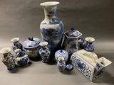 many blue and white vases and cups on the table