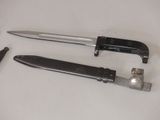 two different types of knives on a white table