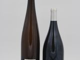 two bottles of wine sitting next to each other on a table