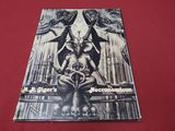 a book with a picture of a demon sitting on top of a table