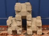 a pile of cement blocks sitting on a rug in front of a blue door