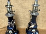 une paire de vases bleus et argentés posés sur une table, sur fond marron