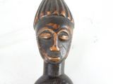 a wooden statue of a person with a hat on