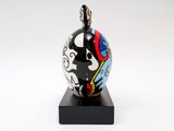 sculpture of a black, white, and red vase with a skull on it