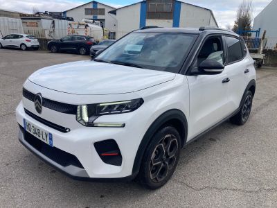 a white suv parked in a parking lot next to a building