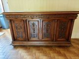 a wooden bar with carvings on the top of it