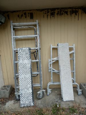 two ladders and a ramp in front of a building