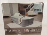 the box of the inflatable air mattress is open on the floor