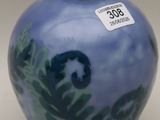 a blue vase that has a picture of a bear on it