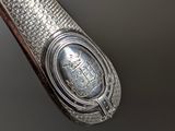 an old silver spoon with a silver seal on it sitting on a table
