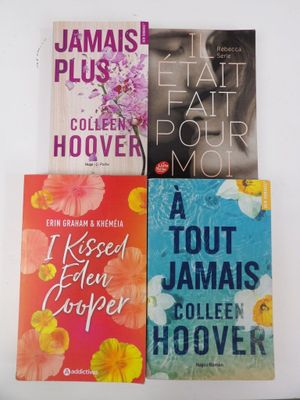 four books are stacked on top of each other on a table