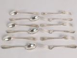 a lot of silver spoons and forks on a table