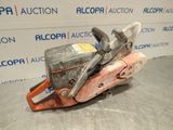 a close up of a chainsaw on a table in front of a wall